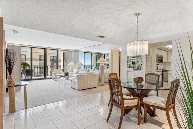 carpeted dining room with floor to ceiling windows and a chandelier