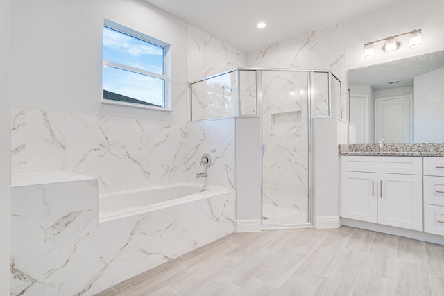 bathroom featuring tile flooring, vanity, and independent shower and bath