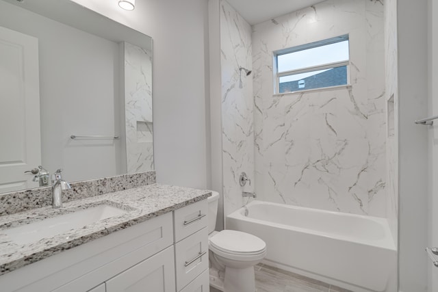 full bathroom with tiled shower / bath, toilet, and oversized vanity