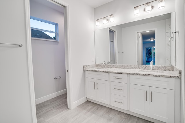 bathroom with oversized vanity and dual sinks