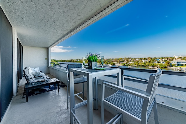 balcony featuring a water view