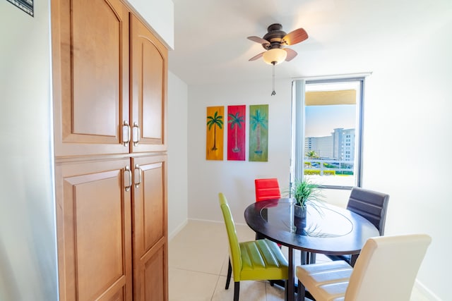 dining space featuring light tile floors and ceiling fan