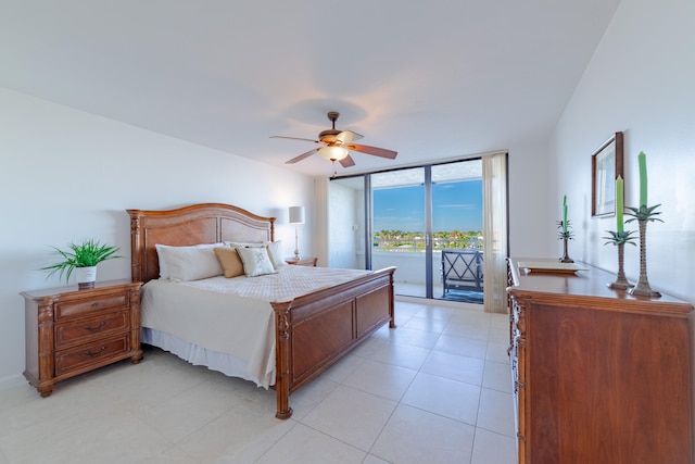 tiled bedroom with access to outside, ceiling fan, and a wall of windows