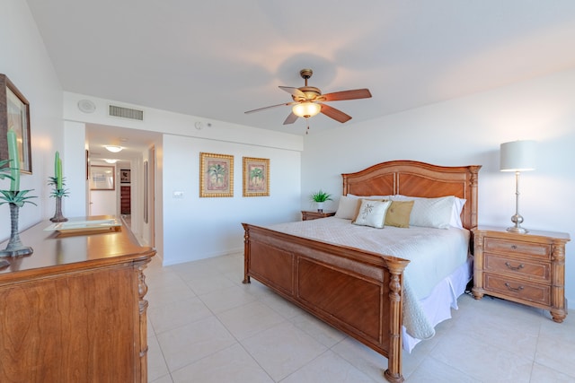 bedroom with ceiling fan, light tile floors, and sink