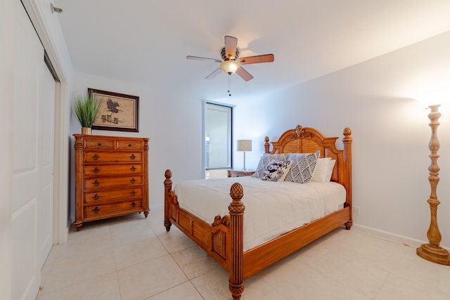 tiled bedroom featuring a closet and ceiling fan