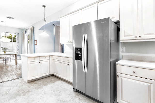 kitchen with light hardwood / wood-style flooring, white cabinets, kitchen peninsula, decorative light fixtures, and stainless steel fridge with ice dispenser