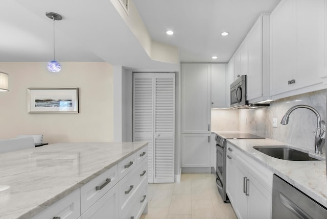 kitchen with white cabinetry, appliances with stainless steel finishes, hanging light fixtures, and sink