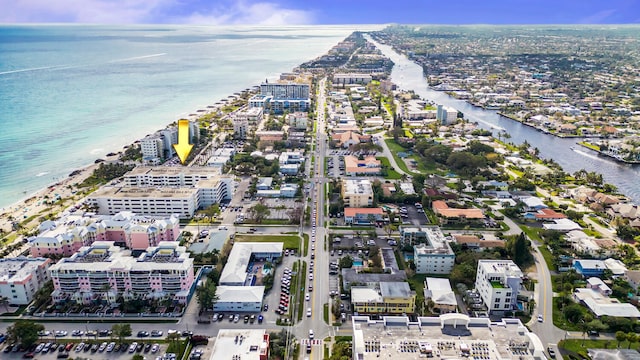 birds eye view of property with a water view and a view of the beach