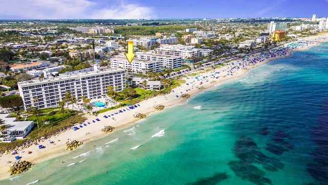 aerial view featuring a water view and a beach view