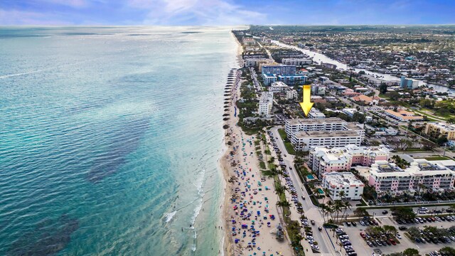 bird's eye view featuring a water view and a beach view