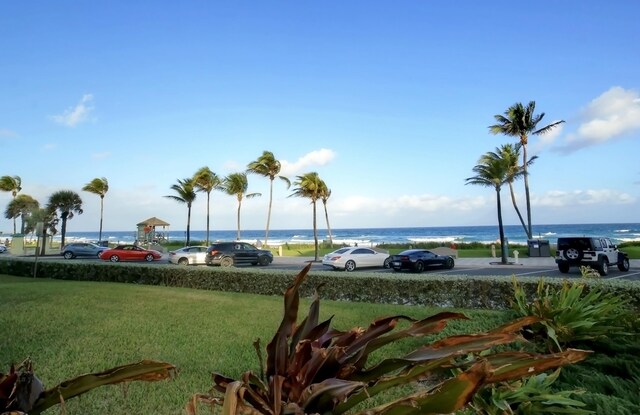 view of community with a lawn and a water view