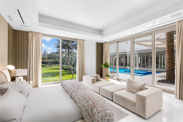 tiled bedroom with access to outside and a tray ceiling