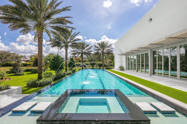 view of swimming pool featuring an in ground hot tub and pool water feature