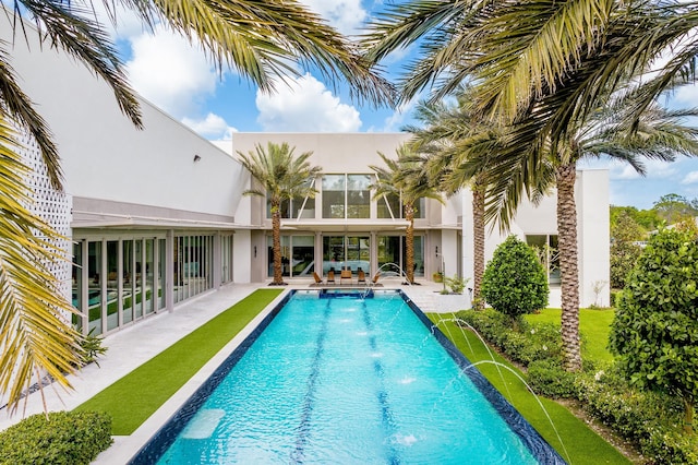 view of swimming pool featuring pool water feature and a patio