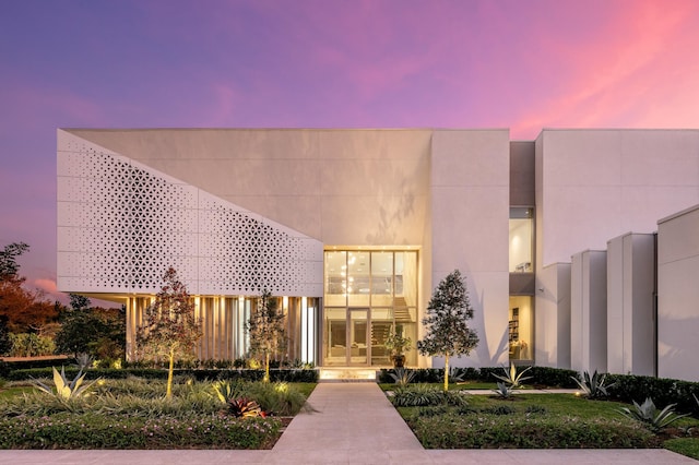 view of outdoor building at dusk