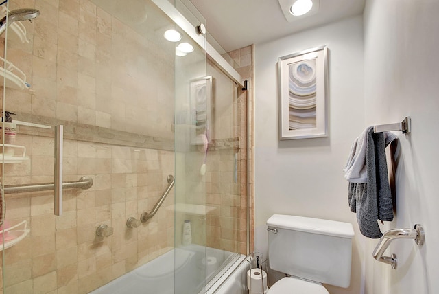 bathroom featuring shower / bath combination with glass door and toilet