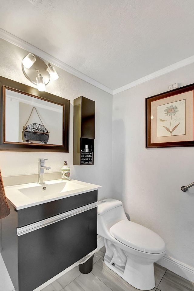 bathroom featuring tile flooring, vanity with extensive cabinet space, a textured ceiling, ornamental molding, and toilet