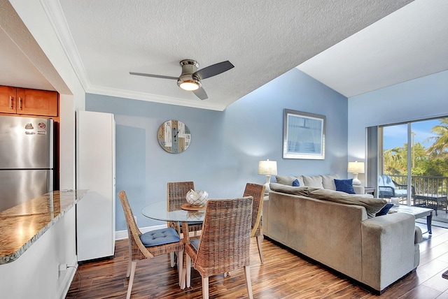 interior space with vaulted ceiling, ceiling fan, hardwood / wood-style flooring, and a textured ceiling