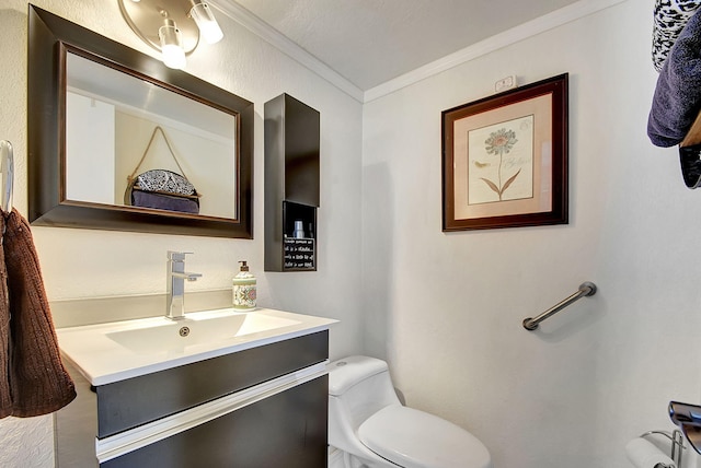 bathroom featuring vanity, toilet, and crown molding