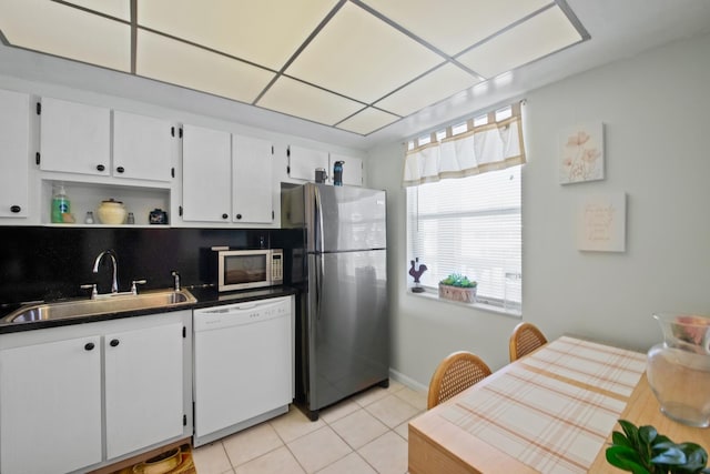 kitchen featuring white cabinets, backsplash, sink, and stainless steel appliances