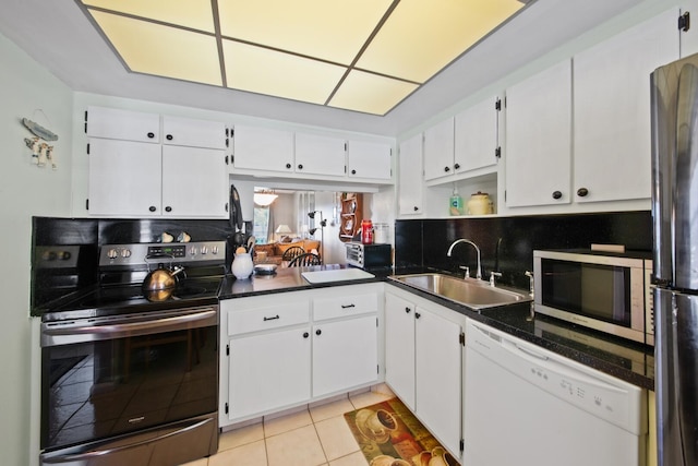 kitchen featuring backsplash, stainless steel appliances, white cabinetry, and sink