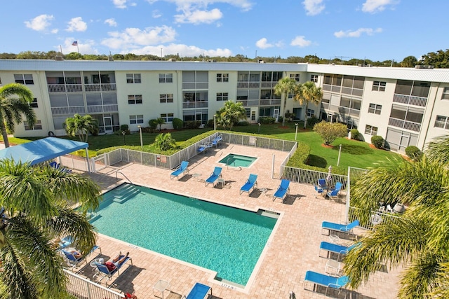 view of pool featuring a lawn and a patio