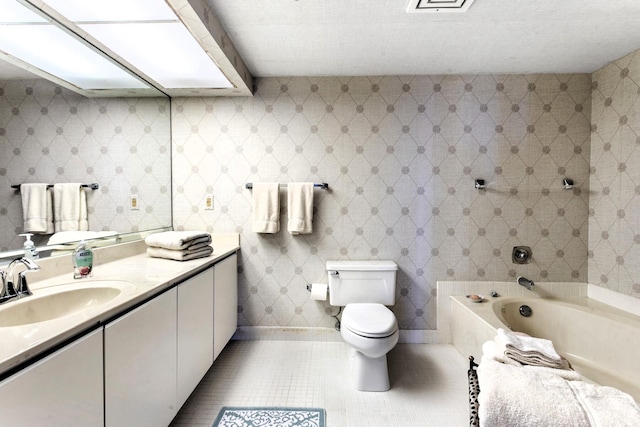 bathroom featuring vanity, a bath, and toilet