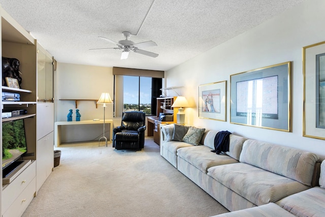 living room featuring light carpet, ceiling fan, and a textured ceiling