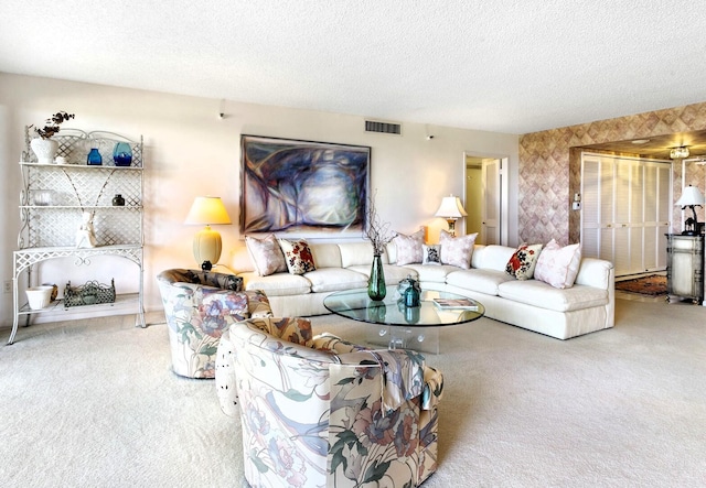 living room featuring a textured ceiling and carpet floors