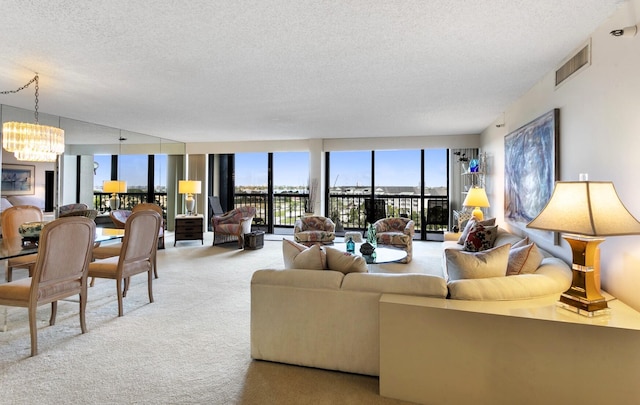 living room with a chandelier, a textured ceiling, and carpet flooring