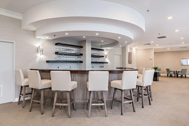 bar featuring light colored carpet and crown molding