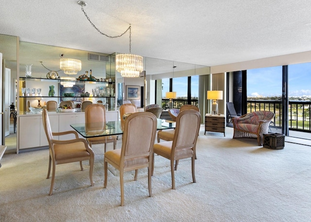 dining area featuring a textured ceiling, light carpet, and a chandelier