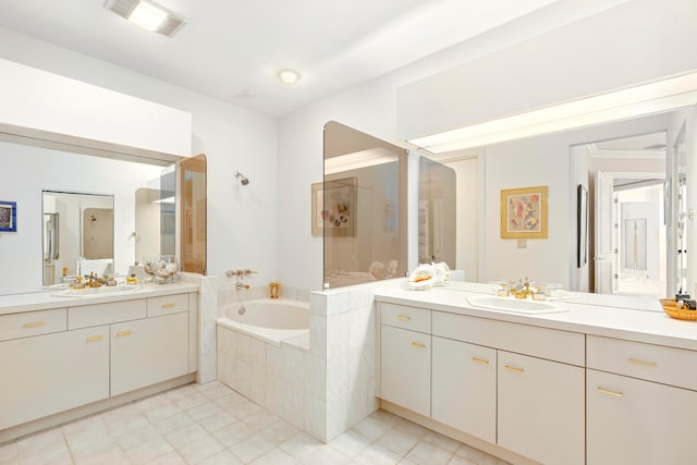 bathroom featuring vanity and tiled tub