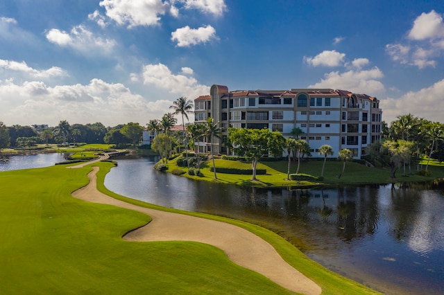 surrounding community with a yard and a water view