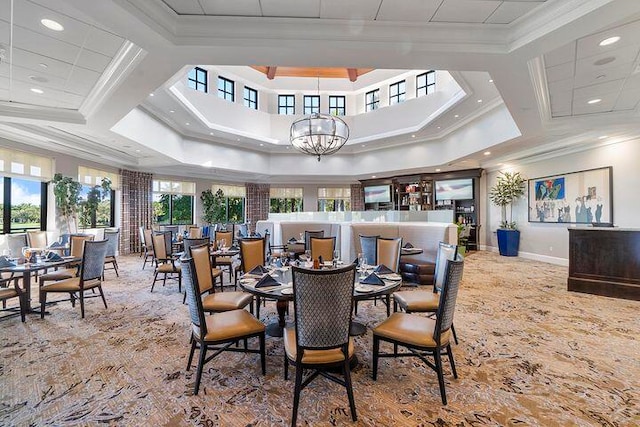 dining room with coffered ceiling, crown molding, and a notable chandelier