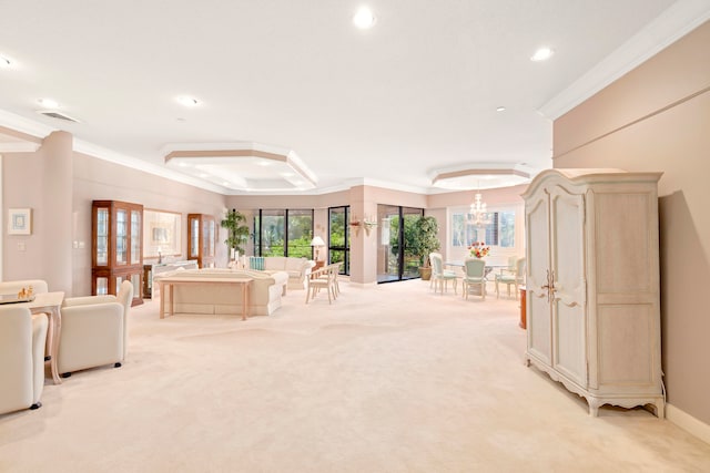 interior space with a raised ceiling, light colored carpet, an inviting chandelier, and crown molding