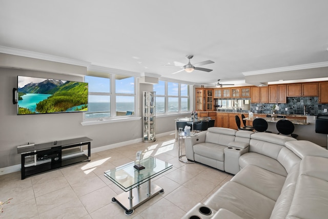 living room featuring light tile floors, ornamental molding, and ceiling fan