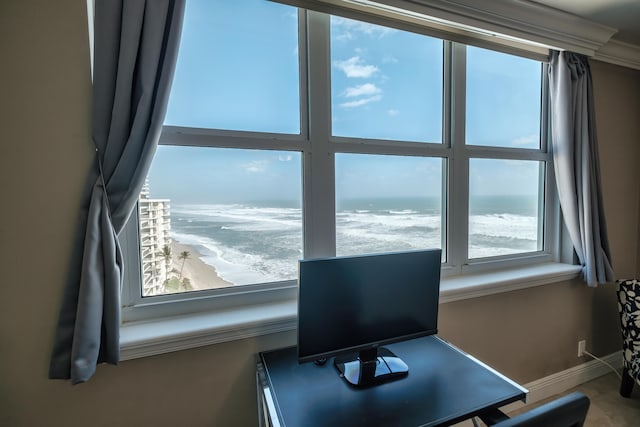 office space featuring a water view, a beach view, and a wealth of natural light