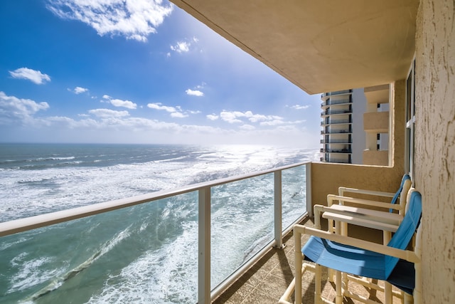 balcony featuring a water view