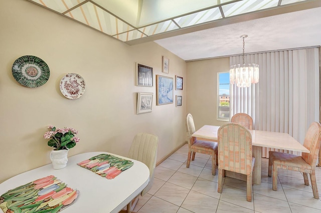 tiled dining room with a chandelier