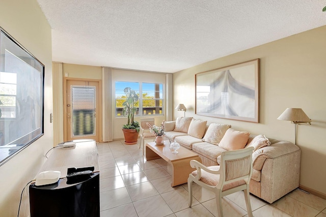 living room featuring a textured ceiling and light tile floors