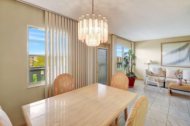 tiled dining room with an inviting chandelier and a healthy amount of sunlight