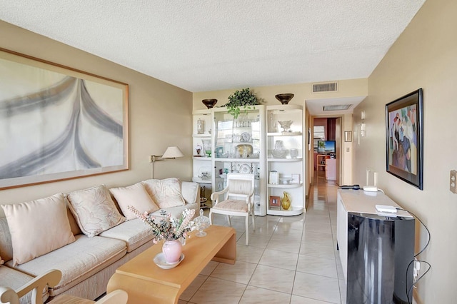 living room with light tile floors and a textured ceiling