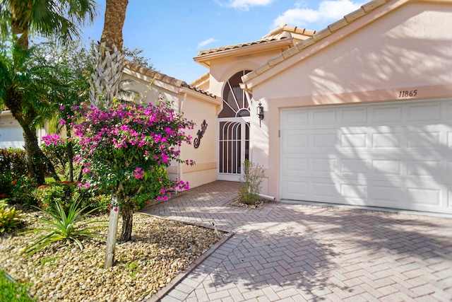 mediterranean / spanish-style house with a garage