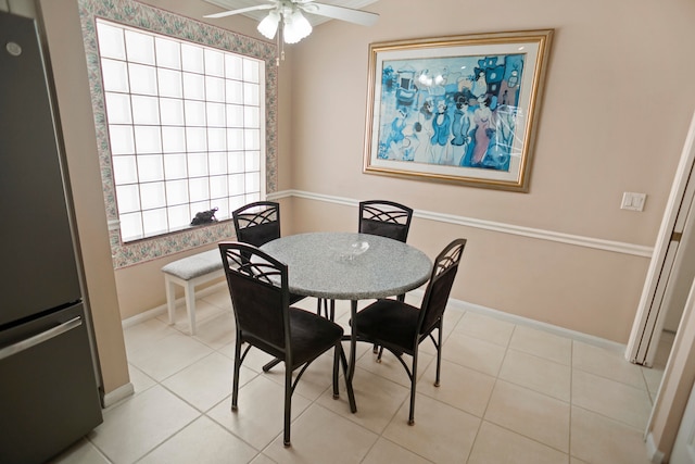 tiled dining space featuring ceiling fan