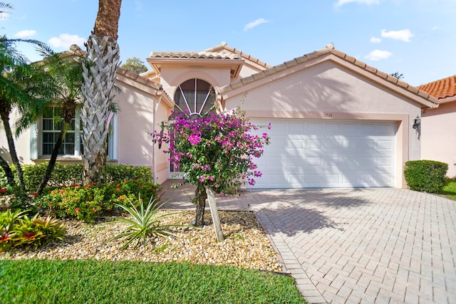 mediterranean / spanish-style home with a garage