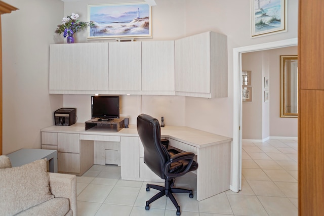 office area featuring light tile patterned floors and built in desk