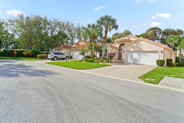 view of front of home with a garage and a front lawn