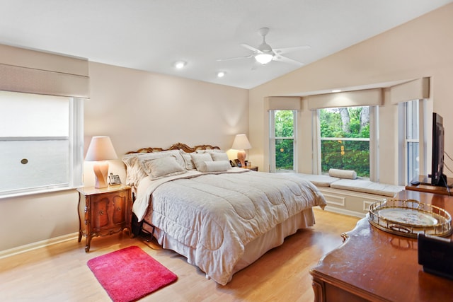 bedroom with light hardwood / wood-style flooring, ceiling fan, and lofted ceiling