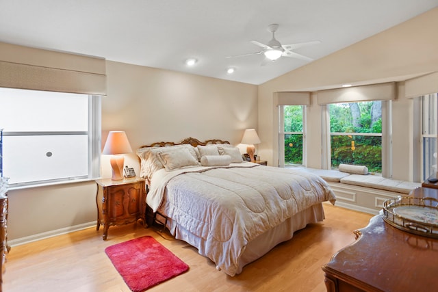 bedroom with ceiling fan, light wood-type flooring, and vaulted ceiling